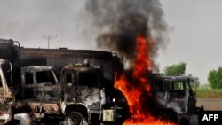 Trucks carrying fuel for NATO forces in Afghanistan burn following an attack by militants southeast of Quetta on October 9.