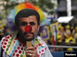 A protester wears a mask depicting Iranian President Mahmud Ahmadinejad rallies outside UN headquarters in New York in September 2011, where he said that "arrogant powers" threatened anyone who questioned the Holocaust. Many diplomats walked out.