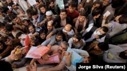 Afghans gather outside the passport office in Kabul in October 2021, two months after the Taliban seized power in Afghanistan. Hundreds of thousands of Afghans have fled the country since then.