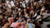 Afghans gather outside the passport office in Kabul on October 6 after Taliban officials announced they would start issuing passports again.