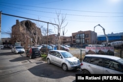 A concrete truck is seen working on a construction site alongside the church, in Georgia's historic Armenian neighborhood.