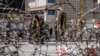 Taliban fighters stand guard at the site of the explosion near the Foreign Ministry in Kabul on March 27.