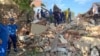 Emergency personnel work at the scene of the destroyed shopping center in Apsheronsk on July 22.