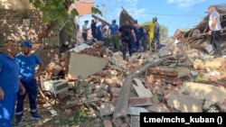 Emergency personnel work at the scene of the destroyed shopping center in Apsheronsk on July 22.