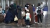 Kyrgyz women and children arrive in Bishkek from a Syrian refugee camp in August.