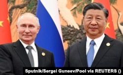 Russian President Vladimir Putin (left) and Chinese President Xi Jinping attend a meeting on the sidelines of the Belt and Road Forum in Beijing on October 18.