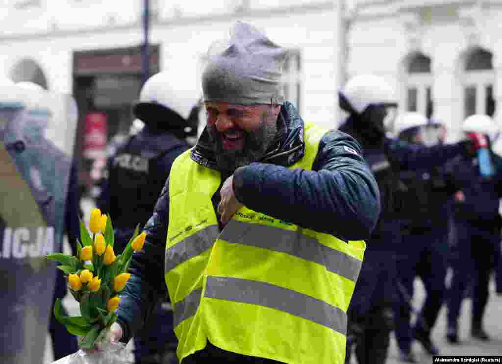 A man reacts after being pepper sprayed during the protests.&nbsp; The EU&#39;s Green Deal initiative includes ambitious targets that include halving the use of pesticides and reducing the use of fertilizers in farming by 20 percent by 2030.&nbsp; &nbsp;