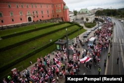 Belarusians march in Warsaw on August 9, 2023, the third anniversary of Belarus's disputed presidential election.