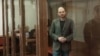 Russian opposition leader Vladimir Kara-Murza stands in the defendant's cage at the Moscow City Court on the final day of his trial, April 17, in which he was sentenced to 25 years in prison on charges of treason and spreading false information. 