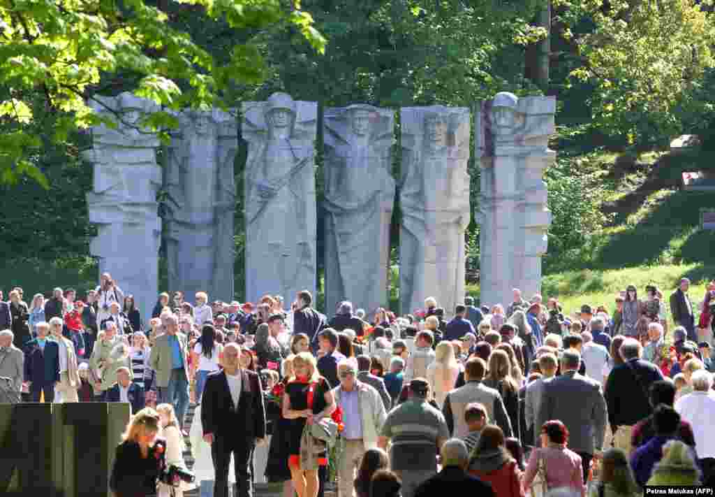 Crowds gather at a memorial to Soviet soldiers in the Antakalnis cemetery in Vilnius in May 2013. The brutalist sculptures were torn down in December 2022 after an earlier UN Human Rights Committee injunction had paused the work. &nbsp;