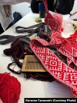 A traditional belt is being made during a clothes-making lesson in Warsaw.