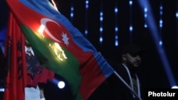 A protester burns the Azerbaijani flag during the opening ceremony of the European Weightlifting Championship in Yerevan on April 14.