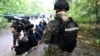 Serbian police detain refugees and migrants in the border zone between Serbia and Hungary on September 12.