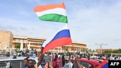 Supporters of Niger's coup wave Nigerien and Russian flags as they demonstrate in Niamey in August. 