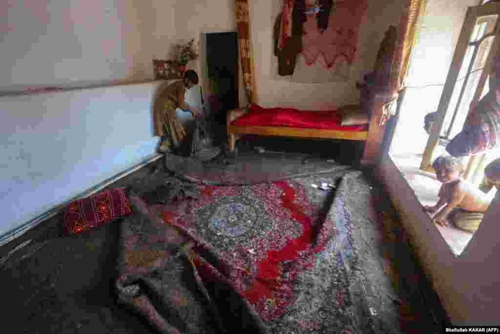 A man begins to clean up his home following the flooding.