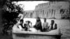 The Moradi family sits on a small boat in the Bamiyan Valley on June 17. The family traveled from Helmand for their summer vacation.