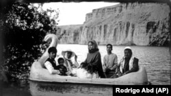 The Moradi family sits on a small boat in the Bamiyan Valley on June 17. The family traveled from Helmand for their summer vacation.