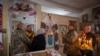 Ukrainian soldiers attend Mass at an Orthodox church near the front lines in the Donetsk region as Ukrainians prepare to celebrate their first Christmas according to a Western calendar.