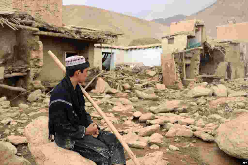 A resident surveys the ruins of his house.