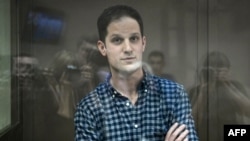 Evan Gershkovich stands inside a defendants' cage before a hearing to consider an appeal on his arrest at the Moscow City Court in Moscow on April 18.