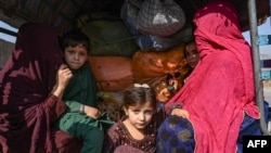 A family of Afghans sit on a vehicle in the Jamrud area of Khyber district on October 6 as they return to Afghanistan, following Pakistan's decision to expel people illegally staying in the country.