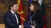 Foreign Ministers Buyar Osmani (left) and Teodora Genchovska shake hands at the signing in Sofia on July 17.