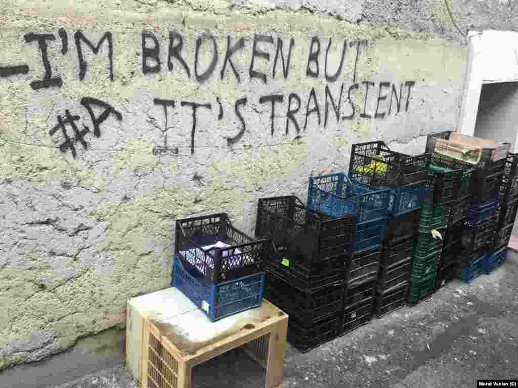 Graffiti next to empty produce boxes. Some locals joked to Vanian that, if the blockade continued, potatoes would soon be listed on the exchange boards alongside dollars and euros.