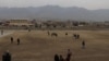 Taliban officials and other spectators gather in Parwan Stadium in Charakar to witness the lashings on October 8. 