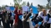 Afghan women and girls take part in a protest in front of the Ministry of Education in Kabul on March 26, 2022, demanding that high schools be reopened for girls.