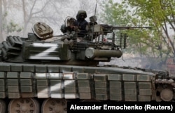 A fighter among Moscow-backed separatist troops is seen atop a tank during fighting near the Azovstal steel plant in the southern port city of Mariupol on May 5.