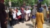 Afghan women protest against the Taliban leader's decree requiring them to cover their faces in public. 