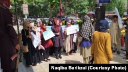 Afghan women protest against the Taliban leader's decree requiring them to cover their faces in public. 