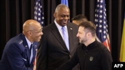 U.S. Chairman of the Joint Chiefs of Staff General CQ Brown (left) and Ukrainian President Volodymyr Zelenskyy at the start of a Ukraine Defense Contact Group meeting in September 2024 (file photo)