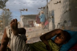 A boy wakes from an afternoon snooze in a village near Bukhara in 2013.