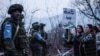 Government-backed Azerbaijani protesters identifying themselves as environmentalists stand in front of Russian peacekeepers last month.