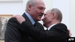 Russian President Vladimir Putin (right) welcomes Alyaksandr Lukashenka to the Kremlin on December 29.