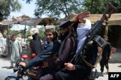 Taliban militants join in Eid celebrations on the streets of Jalalabad during the cease-fire.