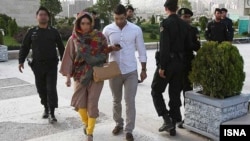 Iranian police warn a woman wearing leggings about her clothing and hair during a crackdown to enforce the country's Islamic dress code. (file photo)