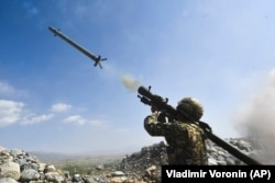 A Kyrgyz soldier deploys a portable air-defense system during CSTO joint military exercises at the Edelweiss training ground in Kyrgyzstan in September 2021.