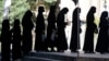 Afghan female students stand in line after they arrive for entrance exams at Kabul University earlier this year. 