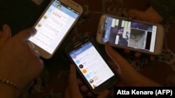 Iranians display their smart phones using the Telegram messenger application, which was officially blocked in the country about a year ago. (file photo)