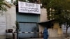 A woman walks past the former Women's Affairs Ministry, which the Taliban has replaced with the Ministry for the Promotion of Virtue and Prevention of Vice.