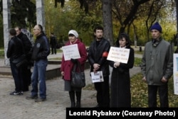 Activist Leonid Rybakov (third from right) at a rally in Tomsk against Vladimir Putin. He's holding a placard saying: "It's time to retire."