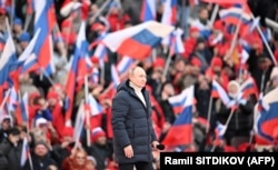 Russian President Vladimir Putin attends a concert marking the eighth anniversary of Russia's annexation of Crimea at a stadium in Moscow on March 18.