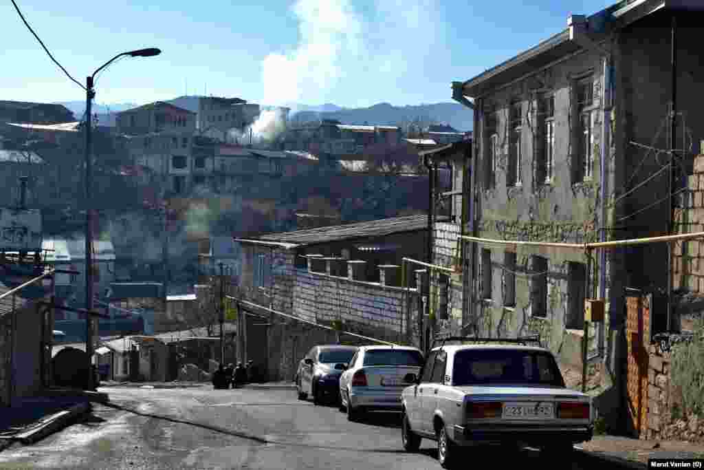 Smoke rises from houses in Stepanakert on December 19. As the blockade continues, some locals are continuing to use firewood to heat their homes due to its low cost. Local authorities have urged residents to reduce electricity usage amid fears vital electrical supply cables that run through Azerbaijani-held territory could be cut. &nbsp;