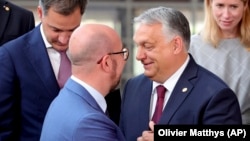 Hungarian Prime Minister Viktor Orban (right) recently wrote to European Council President Charles Michel (left) asking for a "strategic discussion" on the EU's approach to Ukraine in a number of fields.