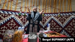 Dressed in traditional Kazakh attire, Marat Darmenov welcomes residents of Bucha into a "Yurt of Invincibility" in January 2023. 