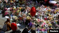 City council employees move flowers from the town hall in Albert Square to St Ann's Square in Manchester on May 24.