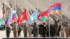 The flags of member countries Tajikistan, Russia, Kyrgyzstan, Kazakhstan, Belarus, and Armenia fly during CSTO training exercises in Tajikistan in 2021.