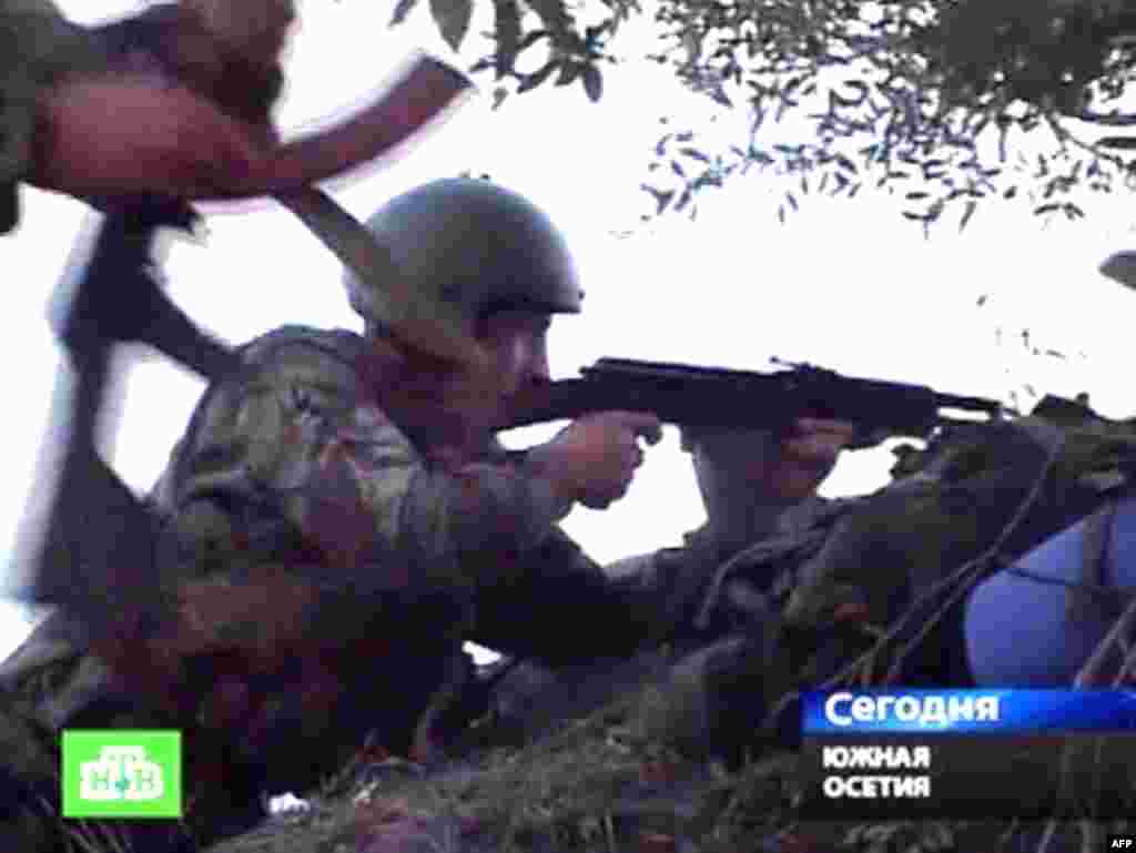 Battles between Georgian troops and South Ossetian separatists raged throughout the day. A grab from Russian television shows South Ossetian troops firing at Georgian troops from an unnamed location close to the capital Tskhinvali. 